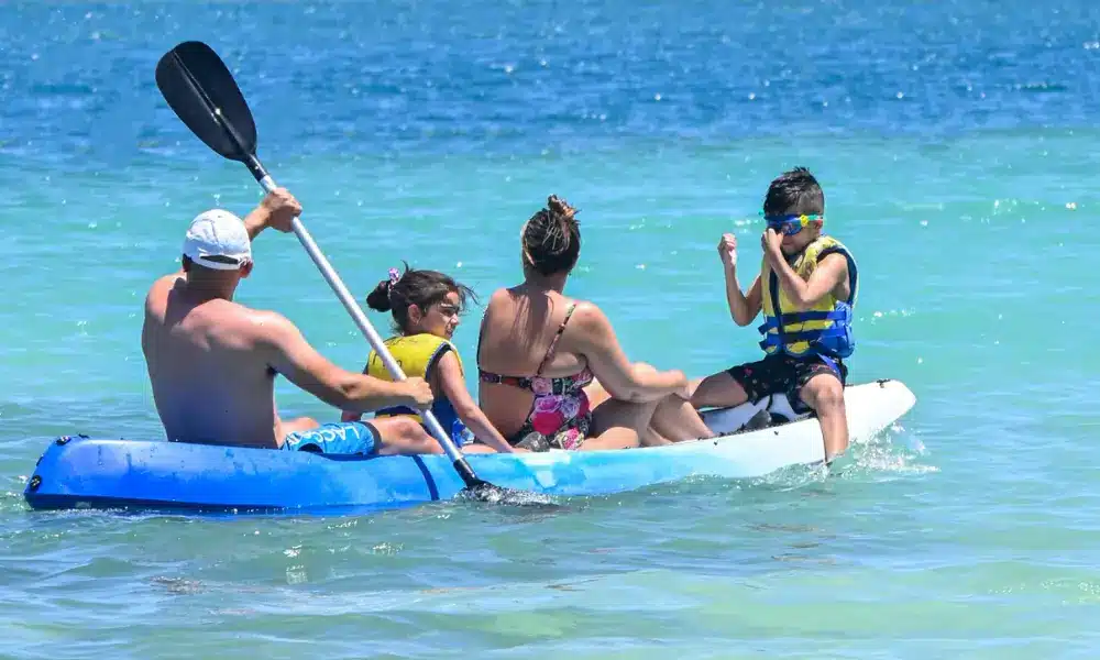 A family kayaking at Plantation Island Resort.