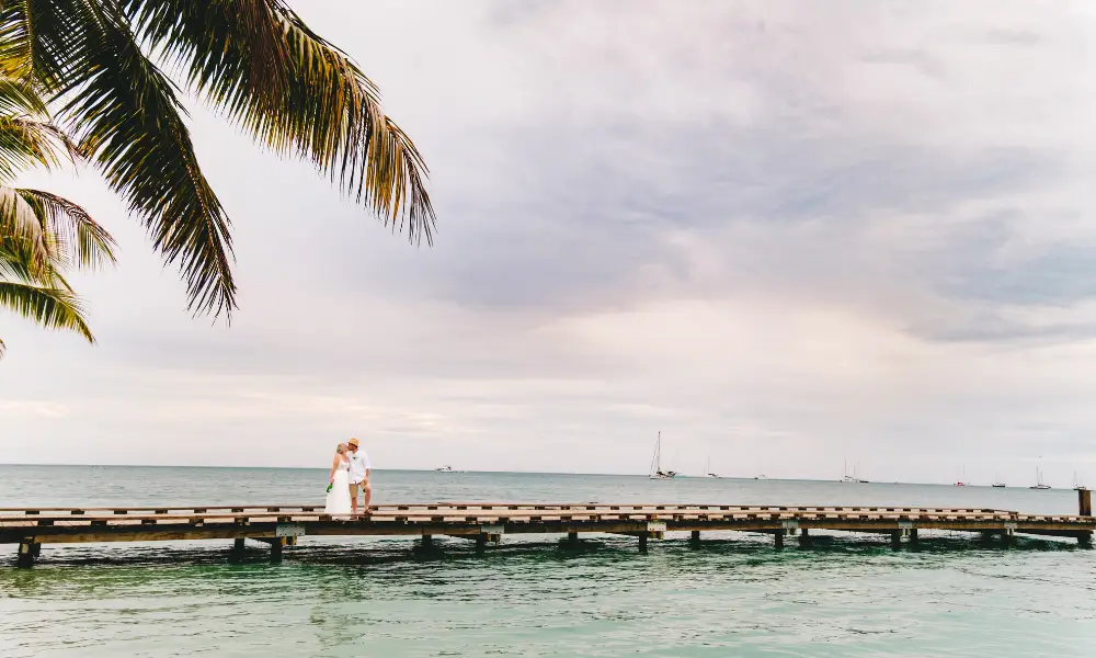 A married couple kiss on the jetty at Plantation Island Resort.