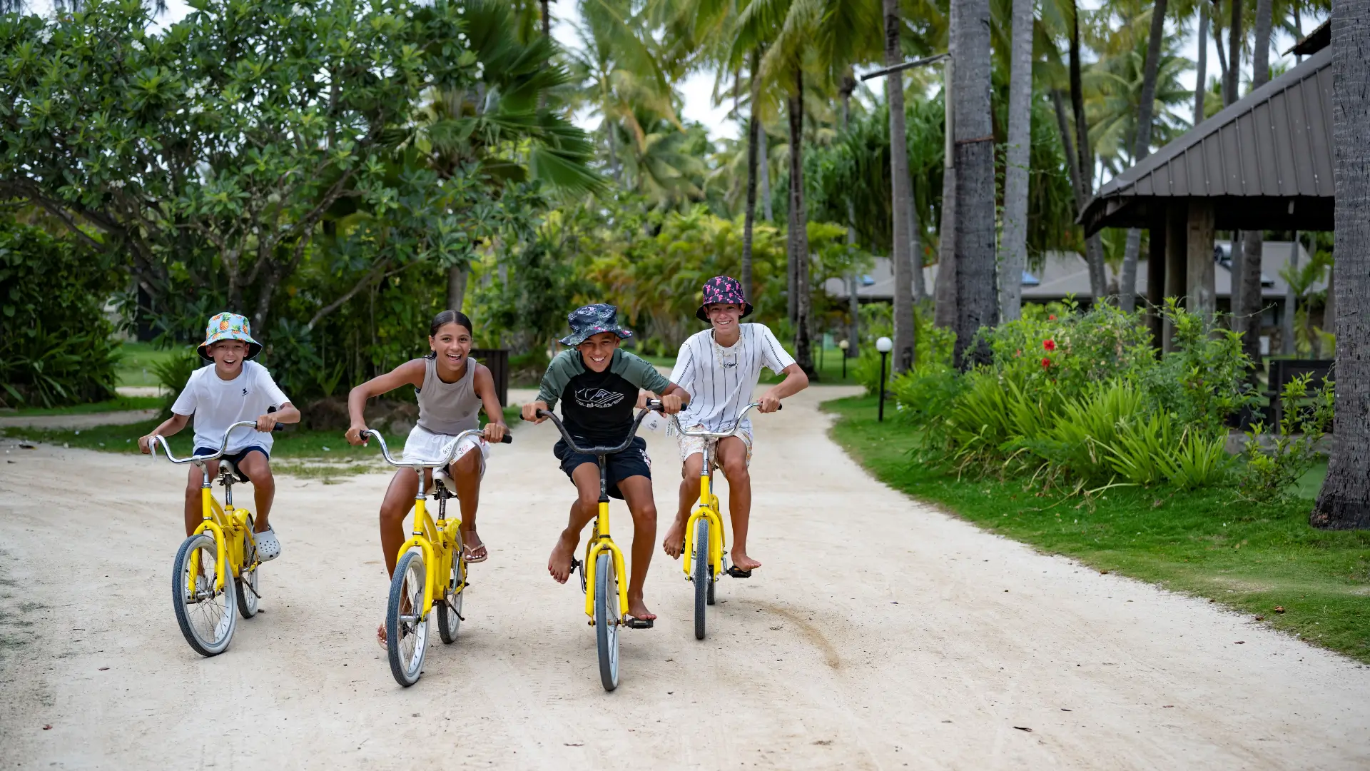 A group of kids cycling through Plantation Island Resort