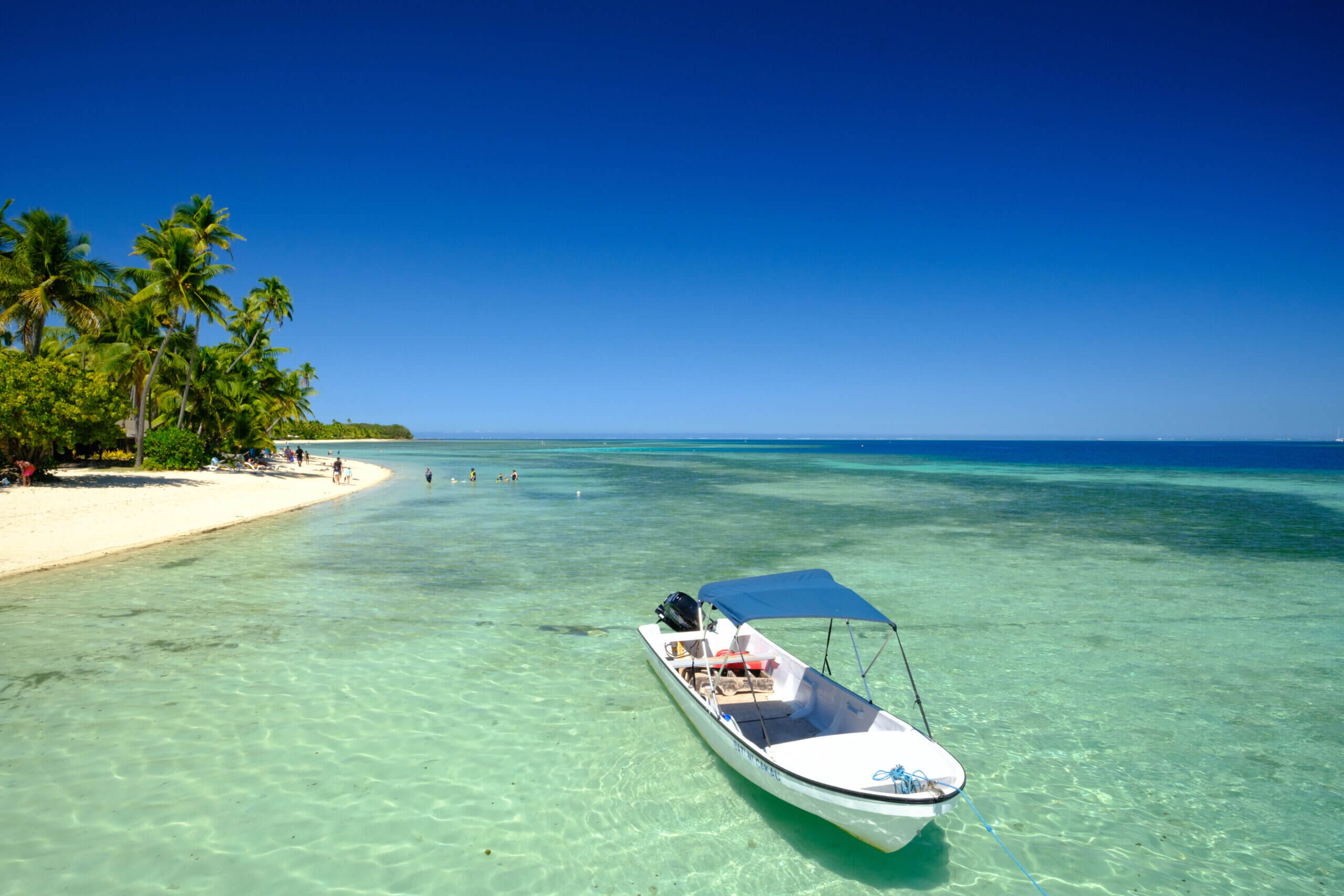 A boat anchored on the lagoon at Plantation Island