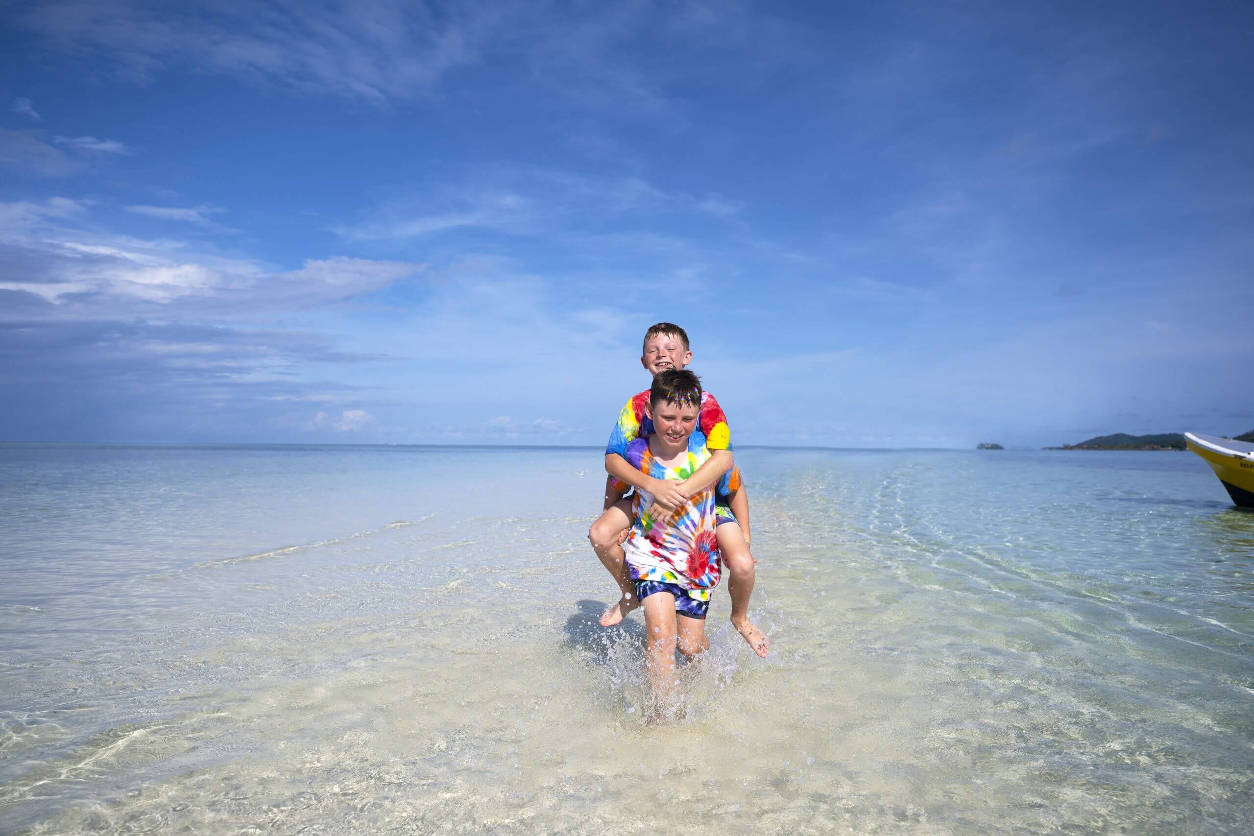 Two children enjoying the shallow lagoon waters off Plantation Island Resort