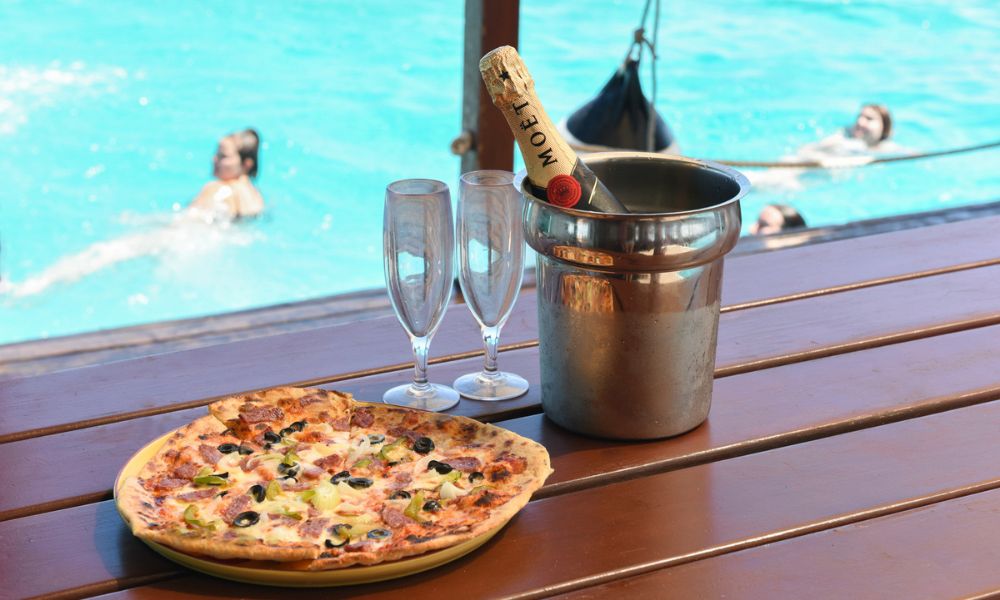 Pizza and champagne by a pool at Cloud 9.