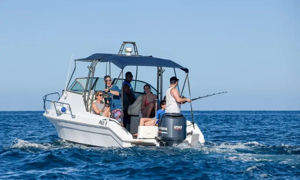 Small fishing boat on deep blue ocean waters during a charter trip