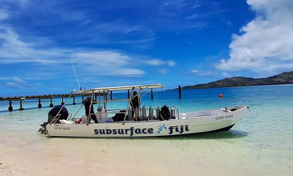 Subsurface Fiji dive boat at the shore of Plantation Island Resort
