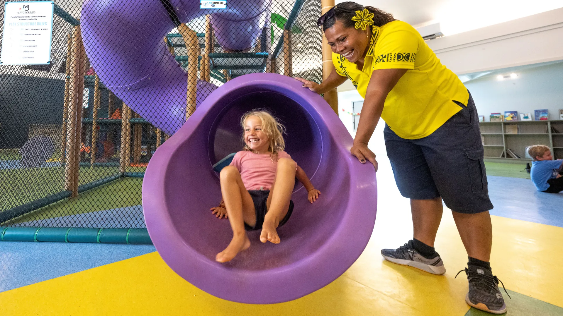 Child sliding down a slide at the Coconut Kids Club, Plantation Island Resort