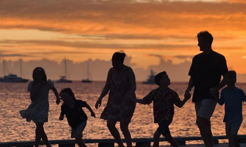 Family walking together at sunset during a Fiji family holiday